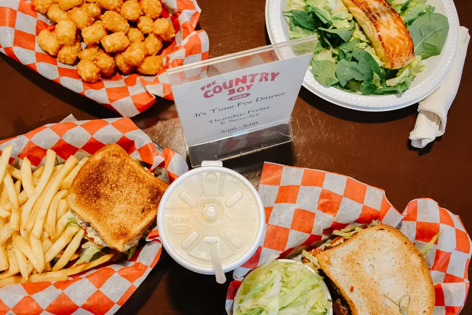 The supper spread: baskets of grilled sandwiches, tots, and fries around the salmon salad and the It's-Time-For-Dinner card.